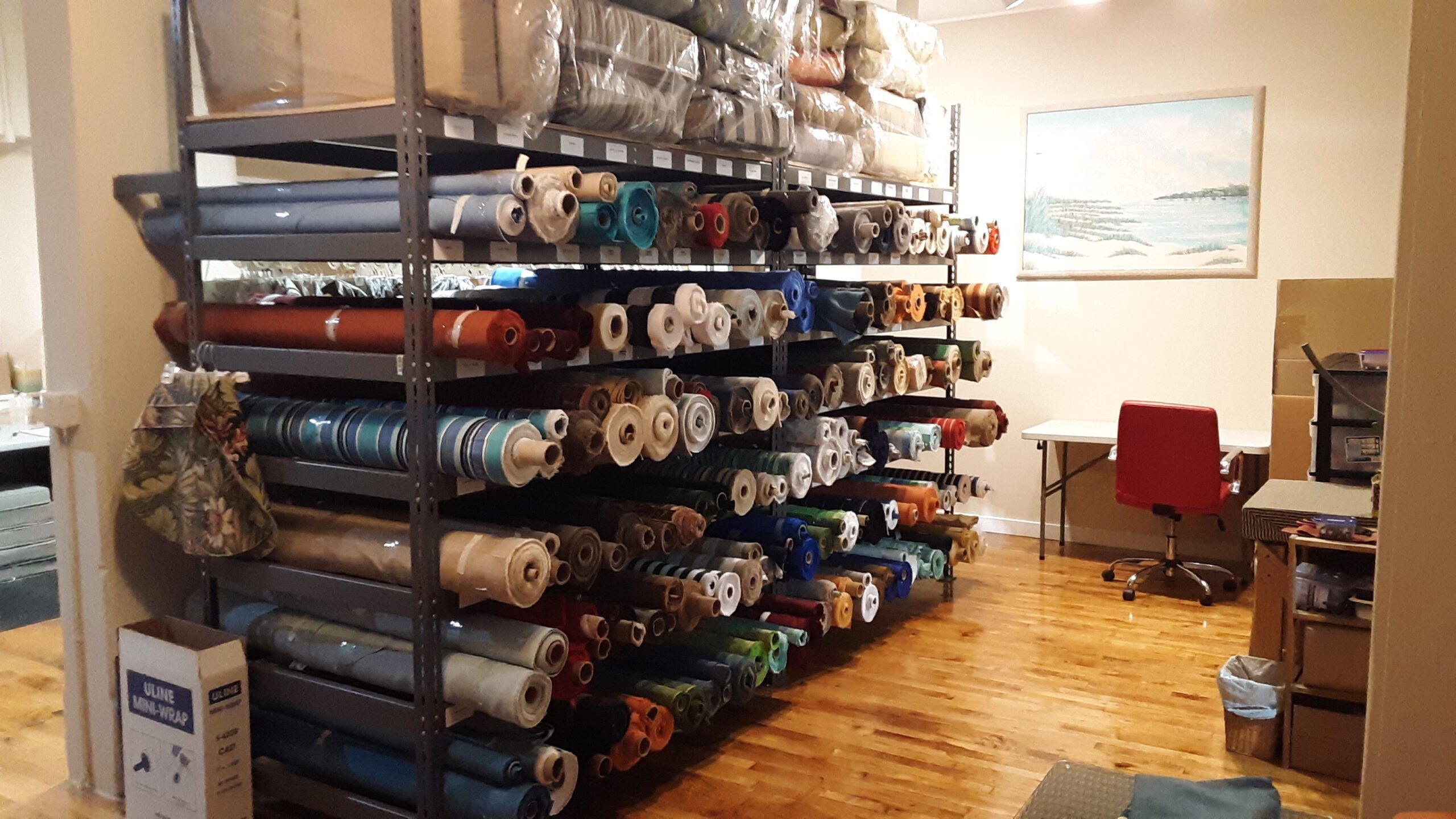An image of a rack full of different fabrics for outdoor cushions